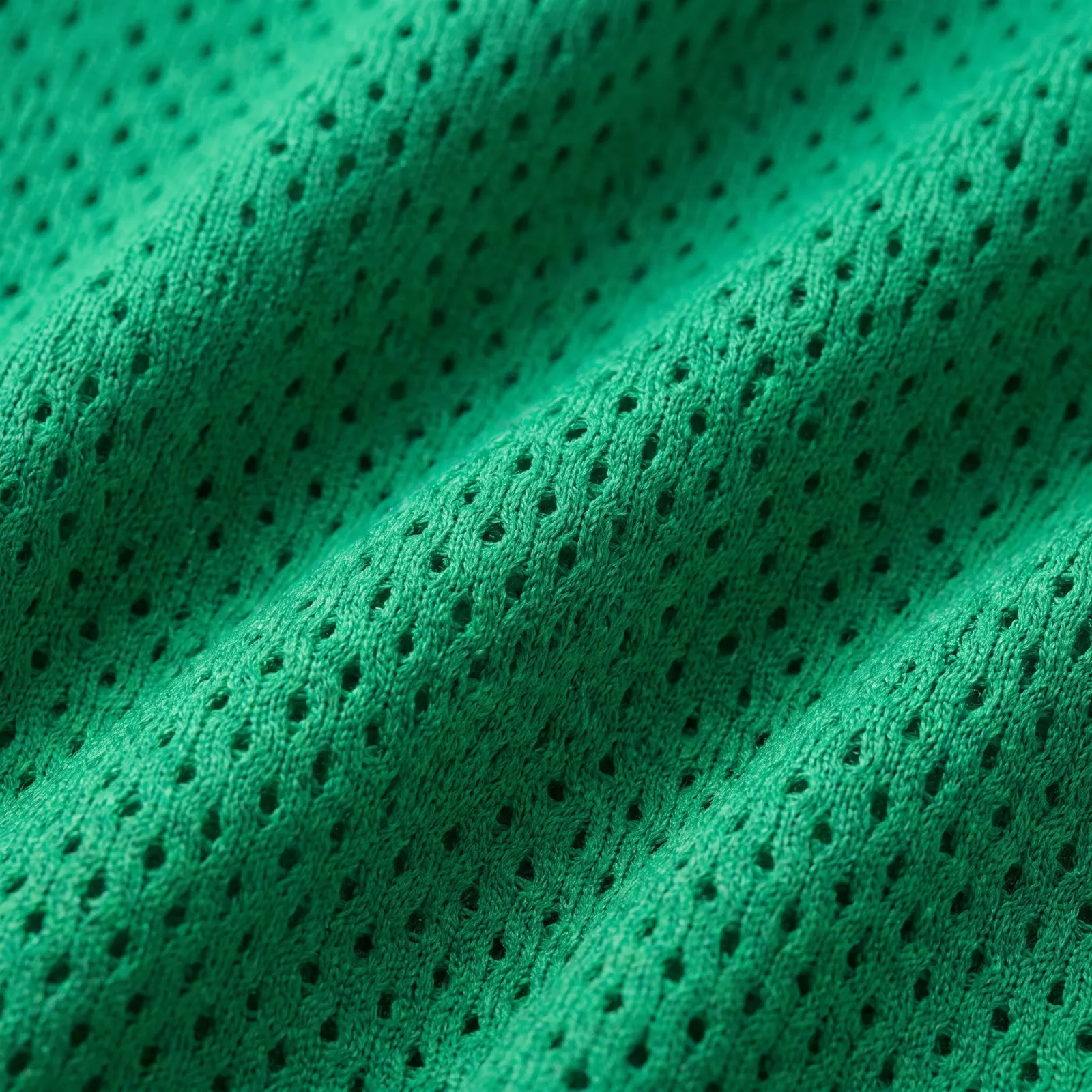 Emerald green birdseye knit in extreme close-up