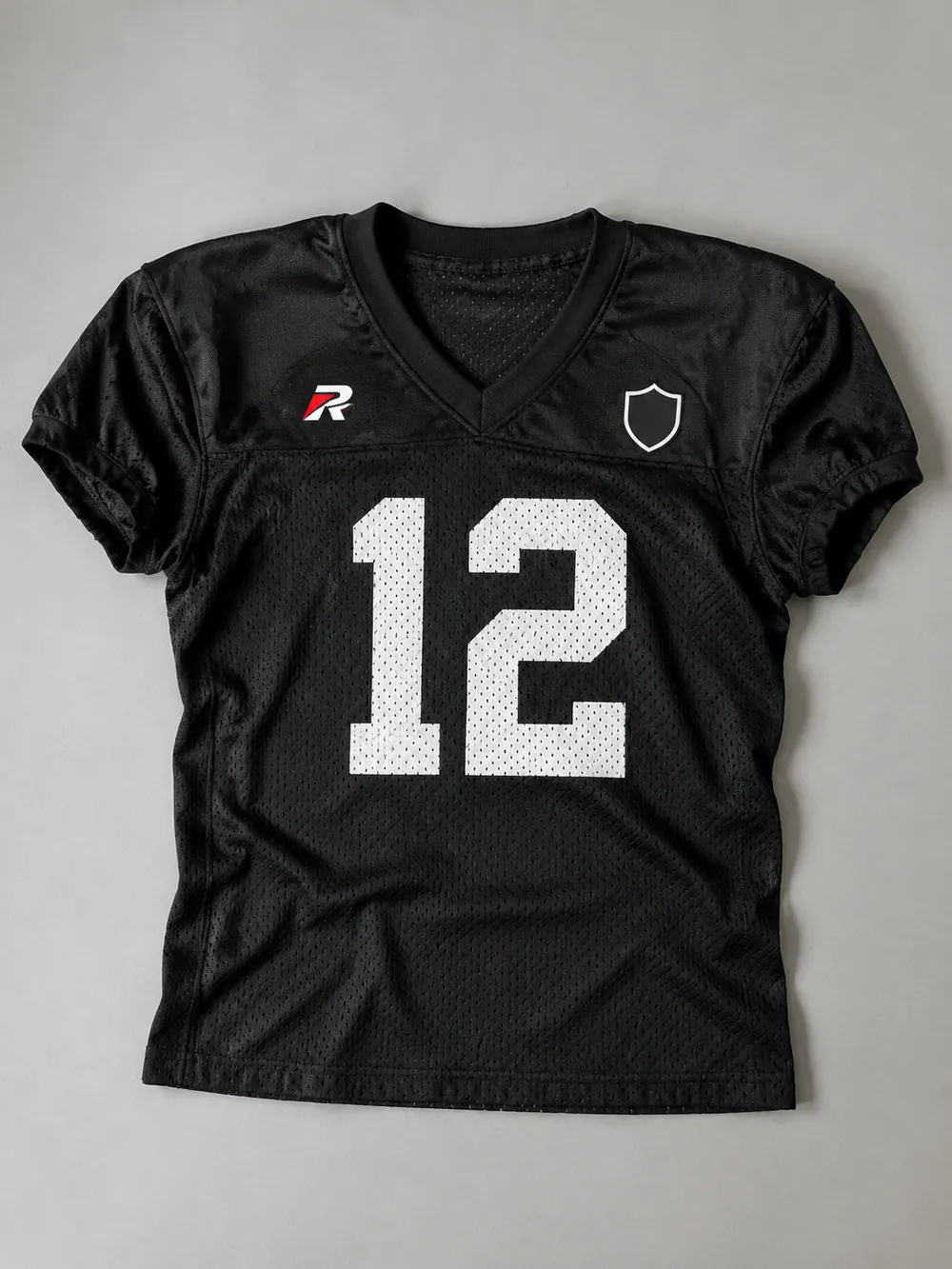 Black practice jersey, mesh body, flat lay