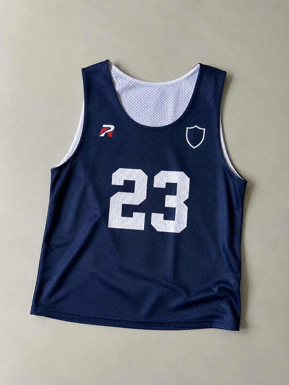 Navy pinnie with number, flat lay