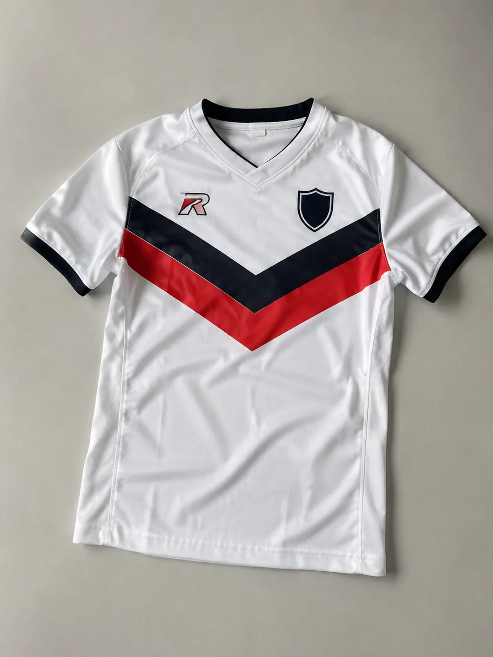 White away jersey with chevron, flat lay