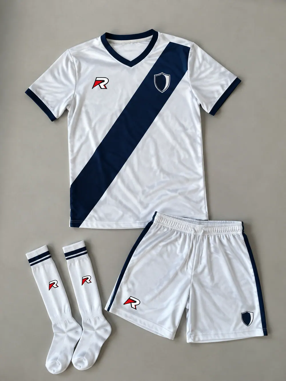 White away kit with navy sash, flat lay