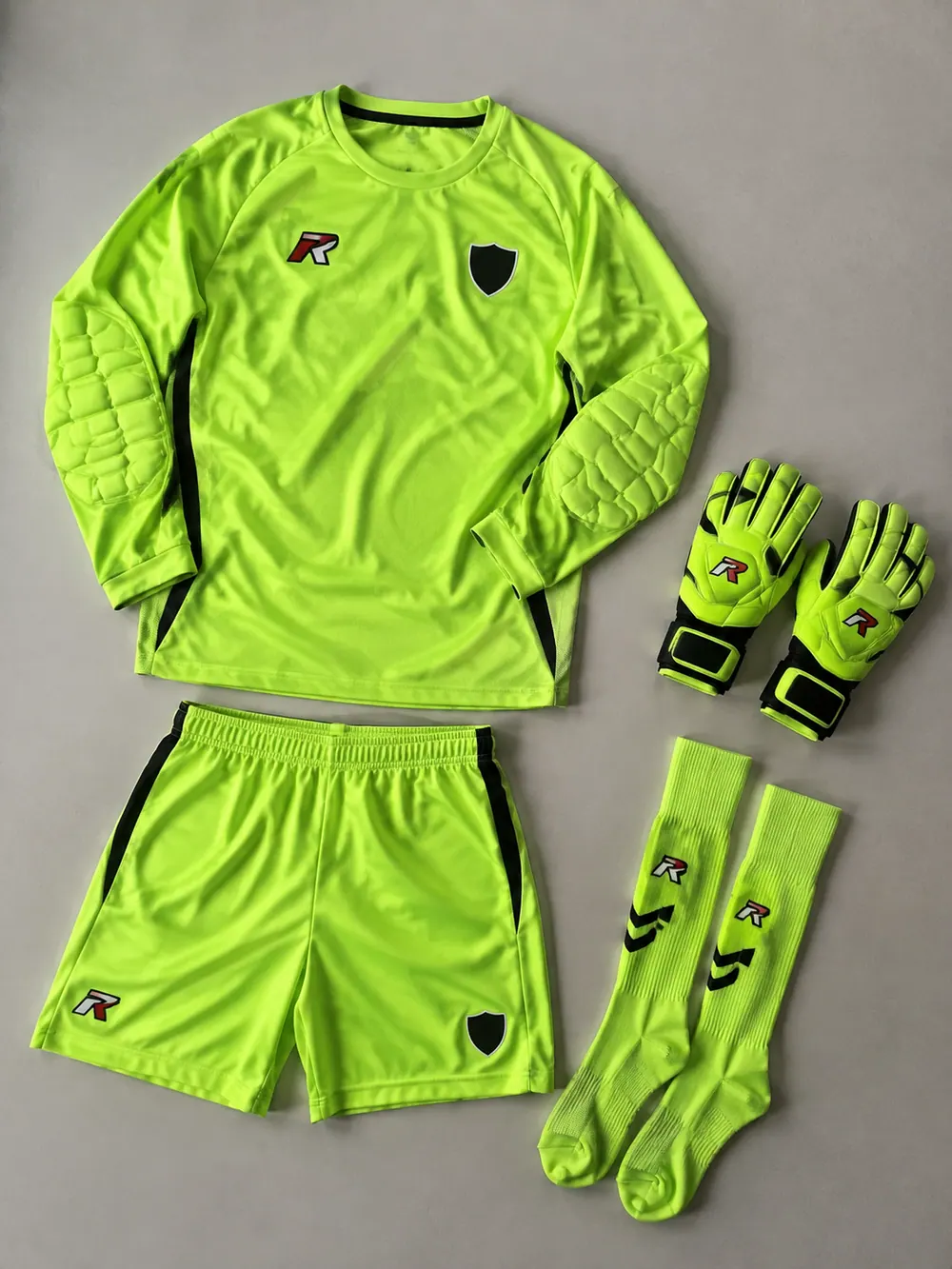 Fluorescent-lime goalkeeper kit with padded long sleeves, flat lay