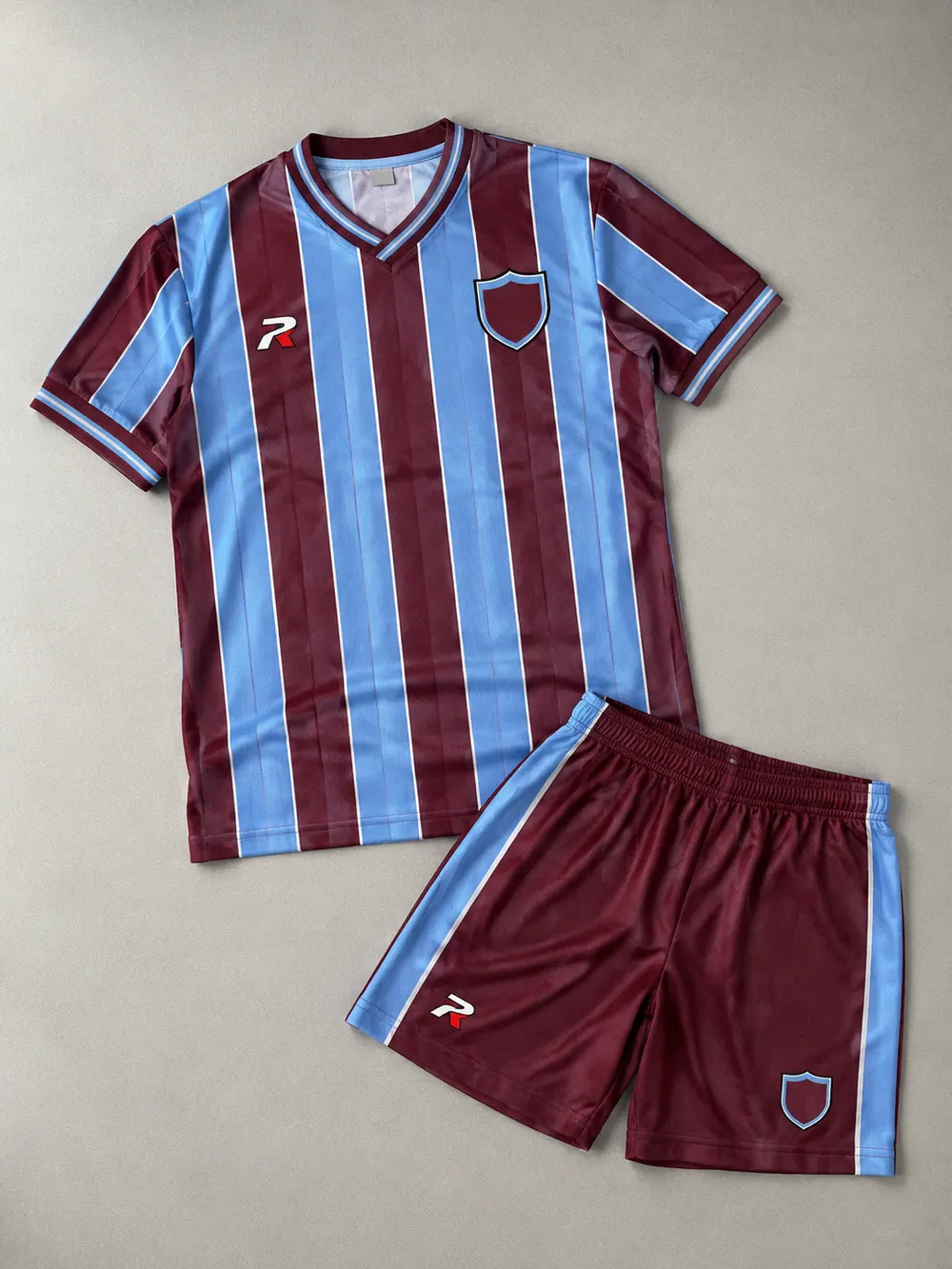 Crest close-up: woven badge on the chest, flat lay