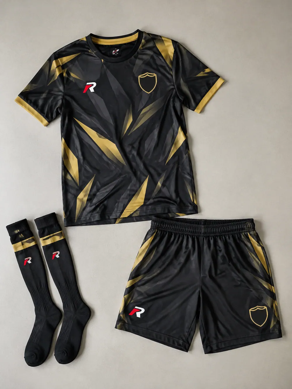 Black and gold third kit with tonal shards, flat lay