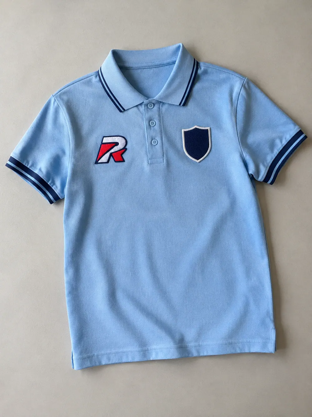Tackle twill & chenille on a polo, flat lay