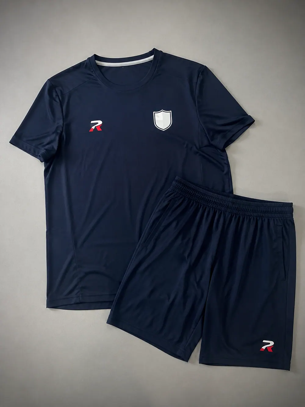 Navy crew tee and shorts, flat lay