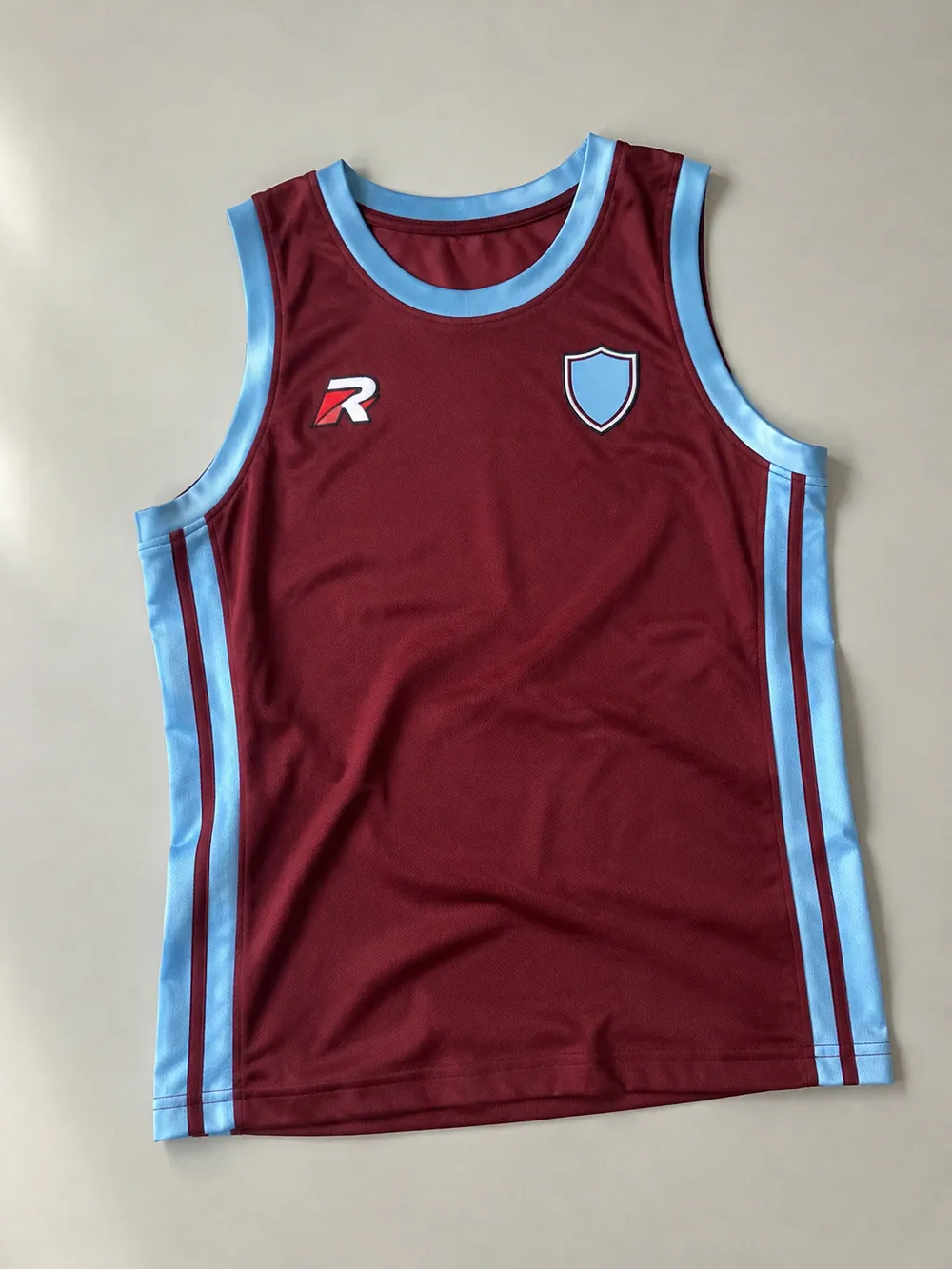 Woven labels & patches on a basketball singlet, flat lay